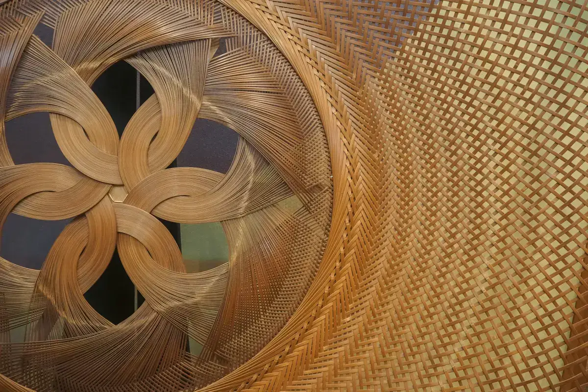 Traditional Japanese bamboo basketwork showcasing intricate woven patterns with a decorative flower-like design at the center